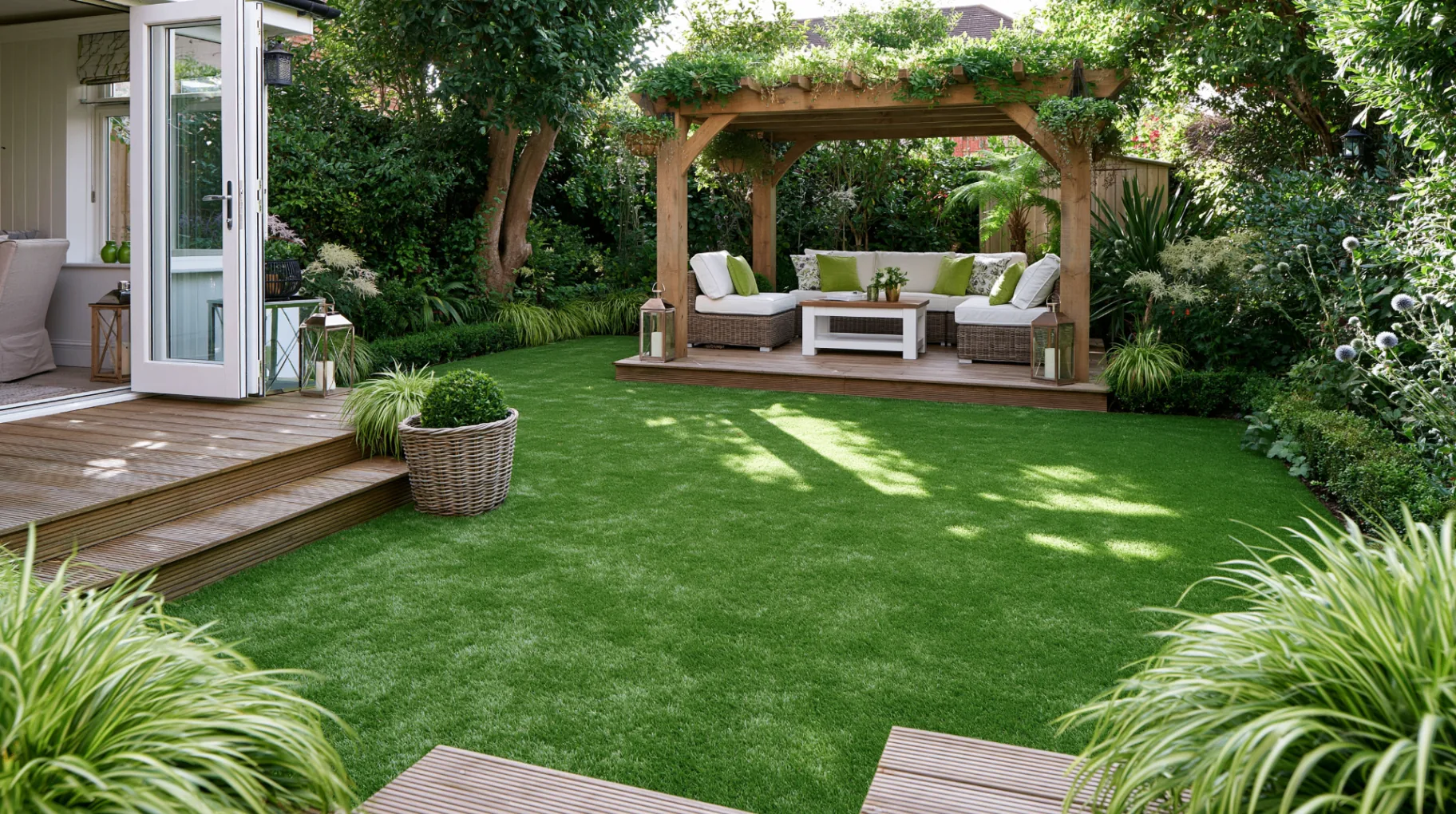 Artificial grass lawn installed alongside a resin bound pathway in a landscaped garden